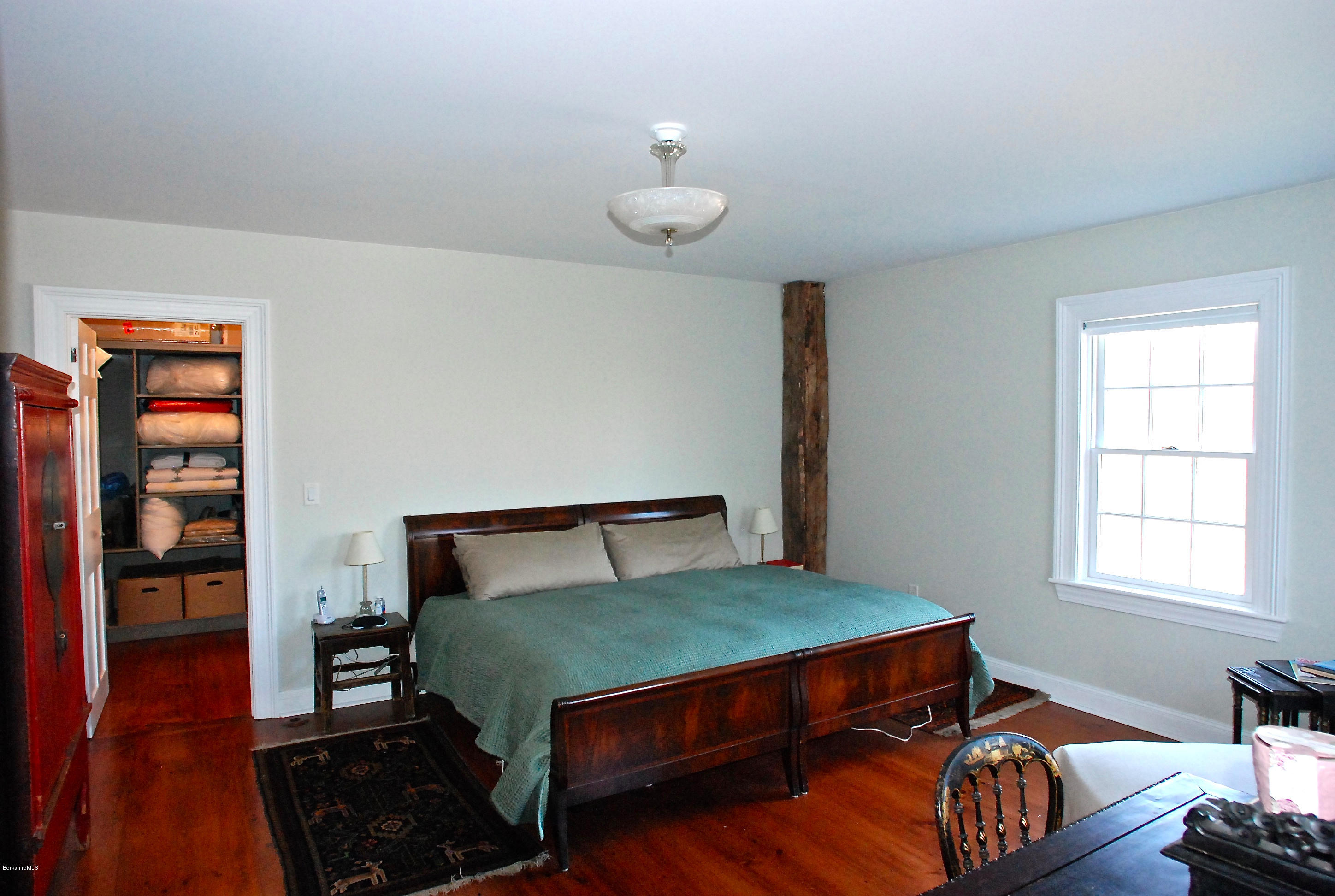 176 Sandisfield Road Sandisfield, MA 01255 - Photo 17 of 28 a bedroom with a bed and wooden floor