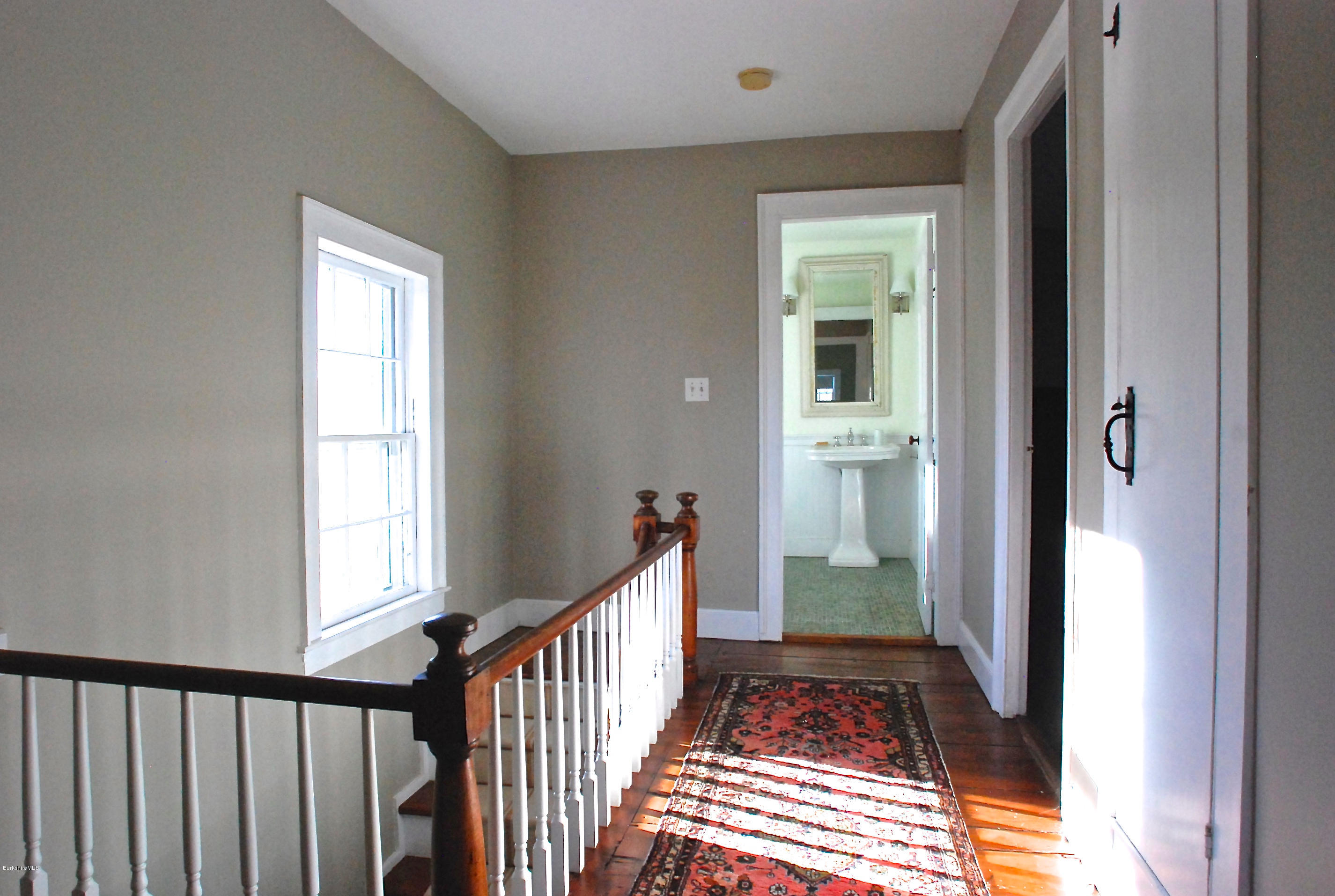 176 Sandisfield Road Sandisfield, MA 01255 - Photo 20 of 28 a view of a hallway view with wooden floor and staircase