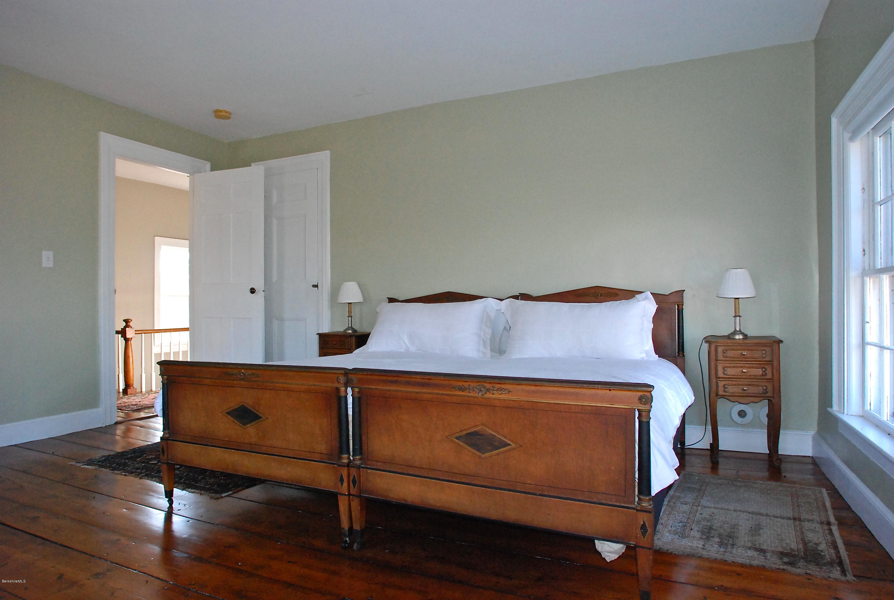 176 Sandisfield Road Sandisfield, MA 01255 - Photo 21 of 28 a room with a bed and wooden floor