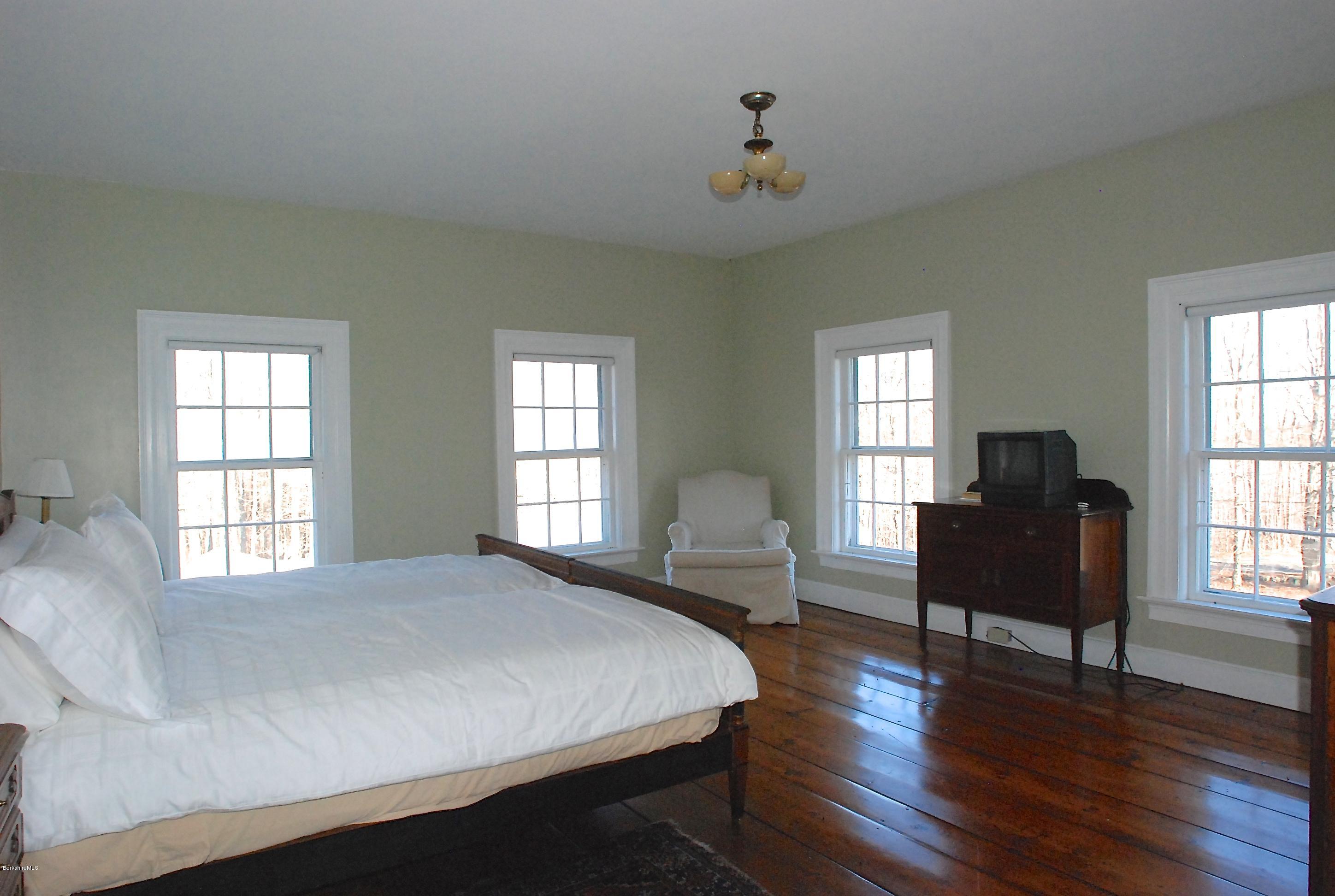 176 Sandisfield Road Sandisfield, MA 01255 - Photo 22 of 28 a bedroom with furniture wooden floor and windows