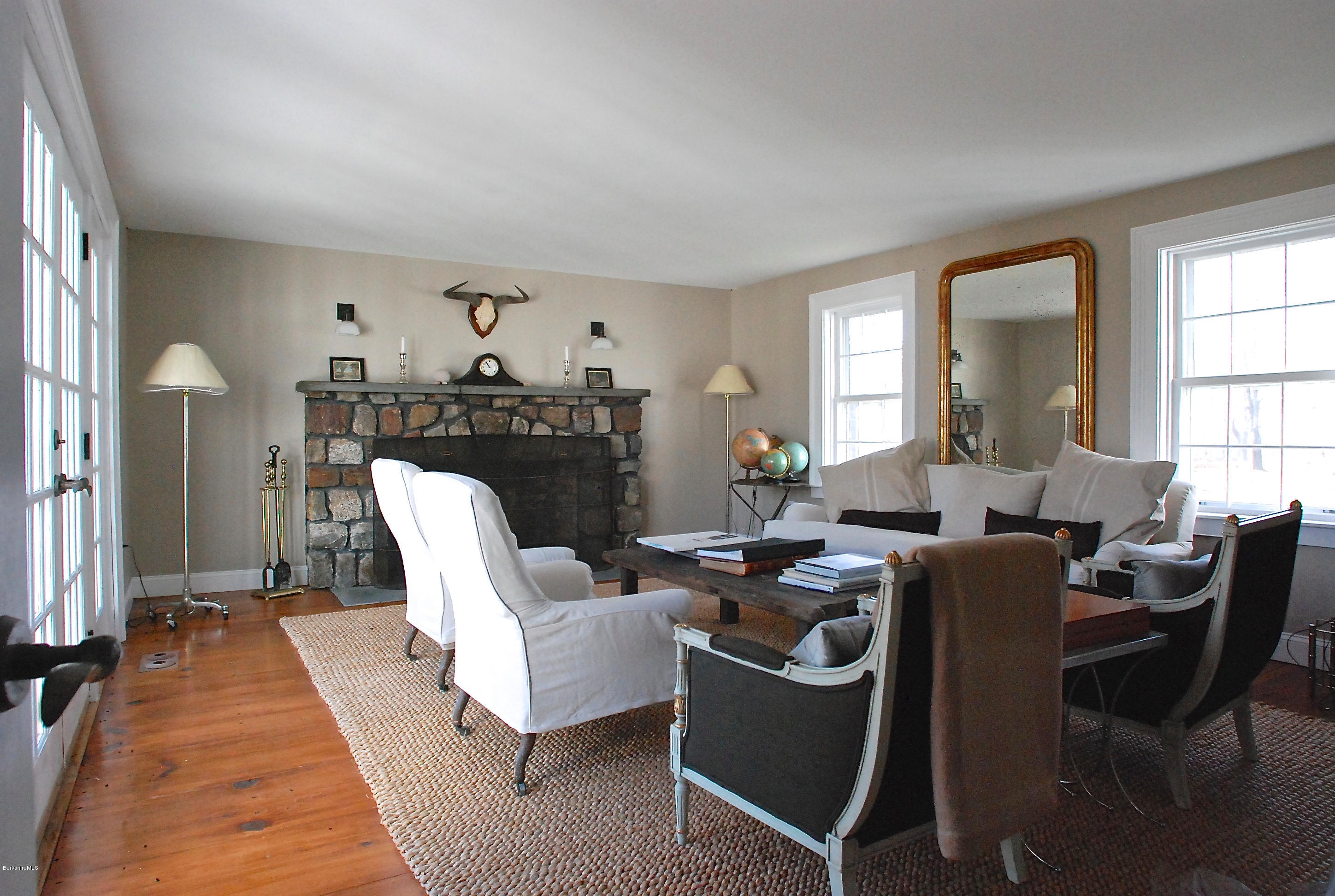176 Sandisfield Road Sandisfield, MA 01255 - Photo 10 of 28 a living room with furniture a fireplace and a large window