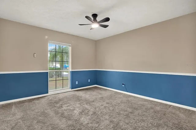 an empty room with closet and windows