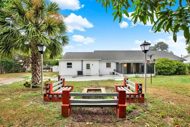 a view of a house with a yard patio and sitting area