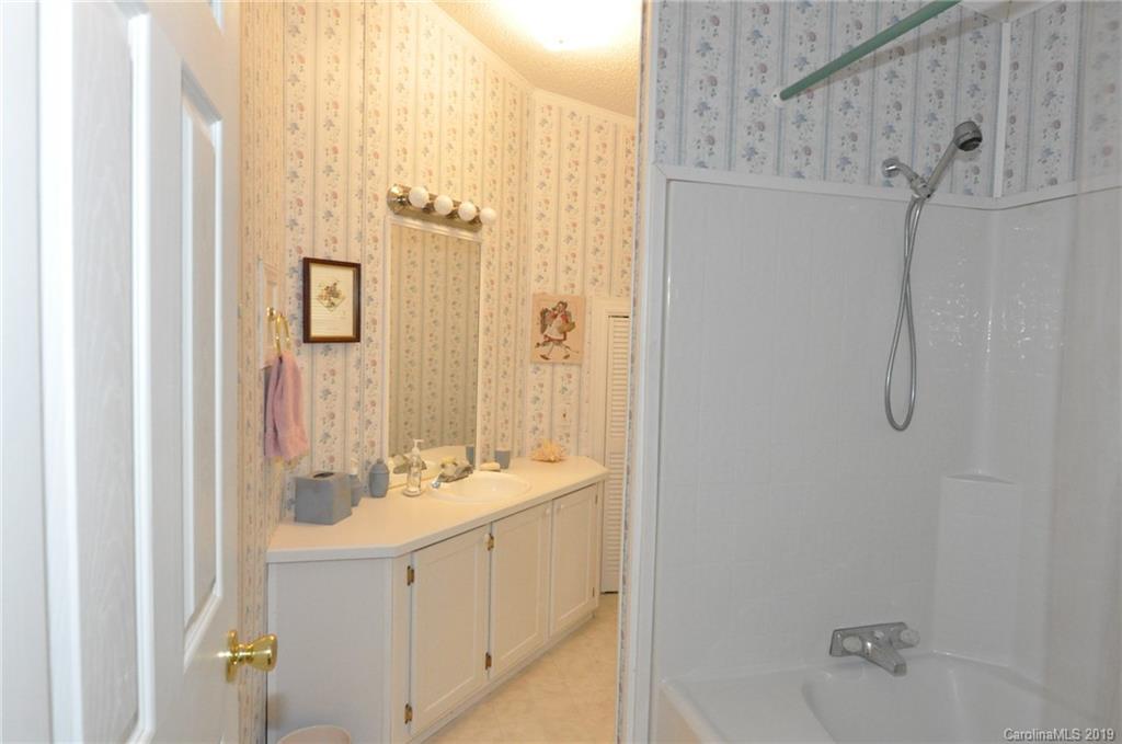 1153 Hopps Road, Unit 46 Chester, SC 29706 - Photo 14 of 22 a bathroom with a sink a mirror and shower