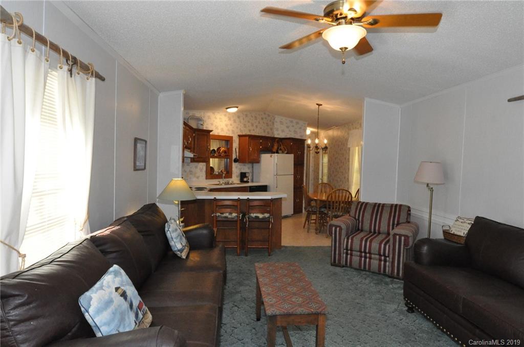 1153 Hopps Road, Unit 46 Chester, SC 29706 - Photo 7 of 22 a living room with furniture and a dining table with wooden floor