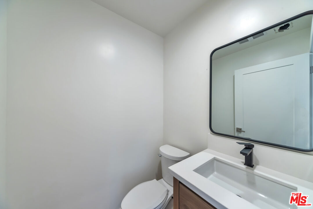 1022-1024 Masselin Avenue Los Angeles, CA 90036 - Photo 9 of 16 a bathroom with a sink and a toilet