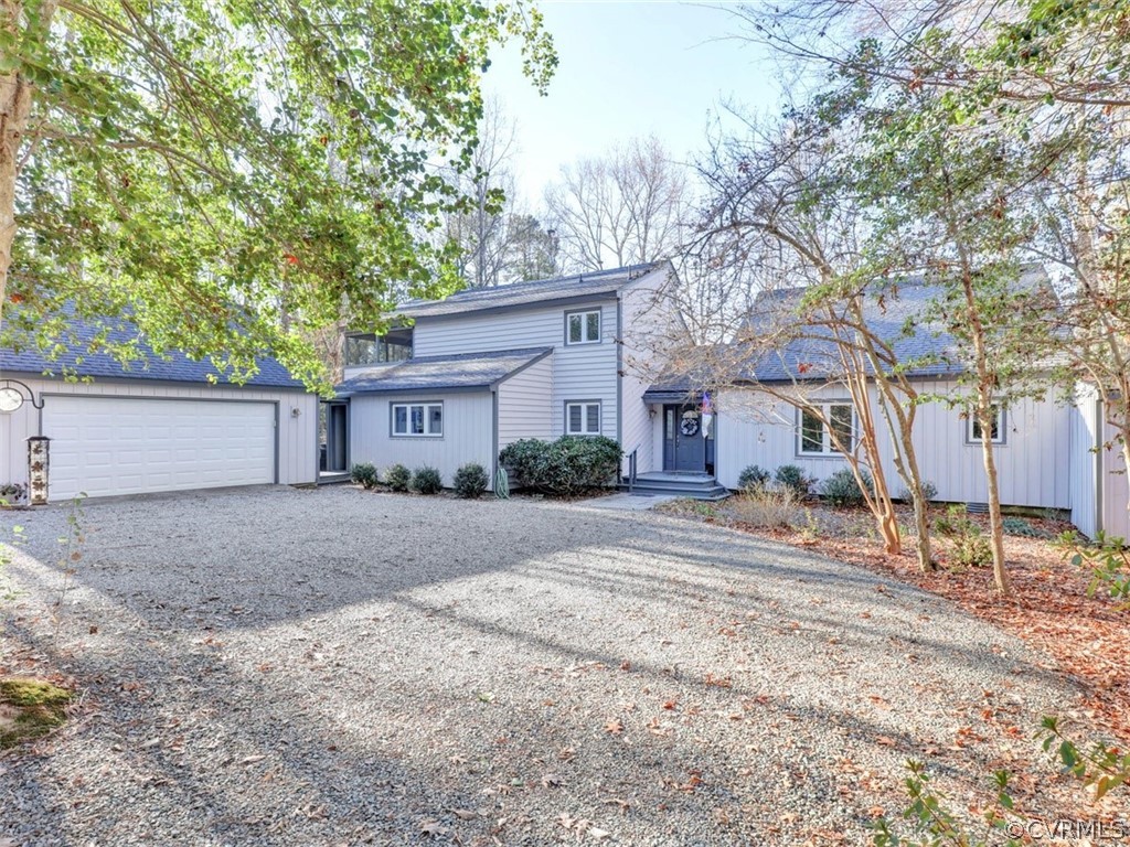 a view of a house with a yard and garage