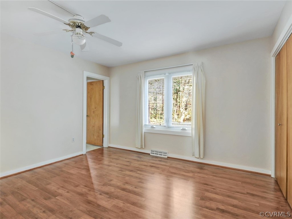 3822 Timber Ridge Road Midlothian, VA 23112 - Photo 25 of 38 a view of an empty room with wooden floor and a window