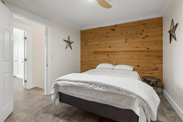 a bedroom with a bed and a potted plant