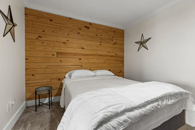 a bedroom with a bed and a table