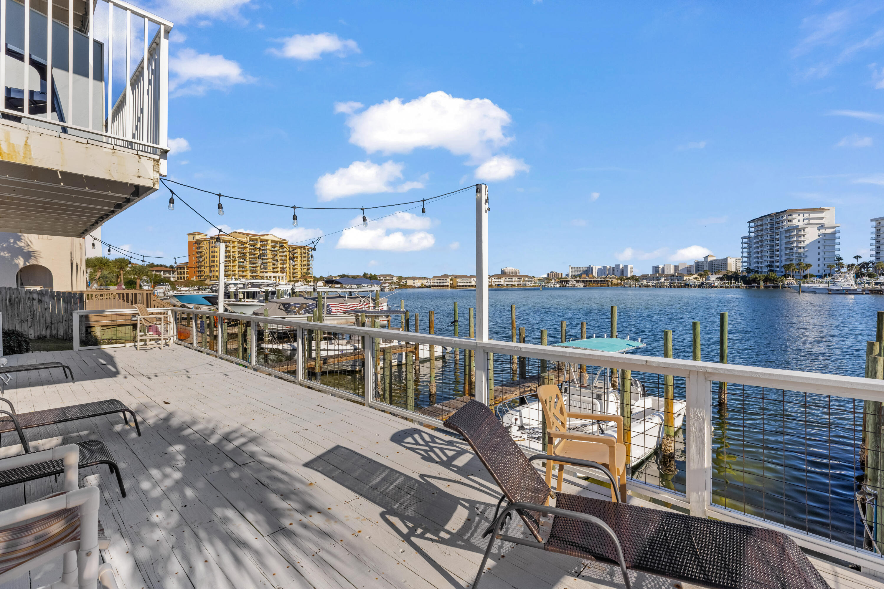 22 Moreno Point Road, Unit 3 Destin, FL 32541 - Photo 9 of 43 a view of a balcony with wooden chairs