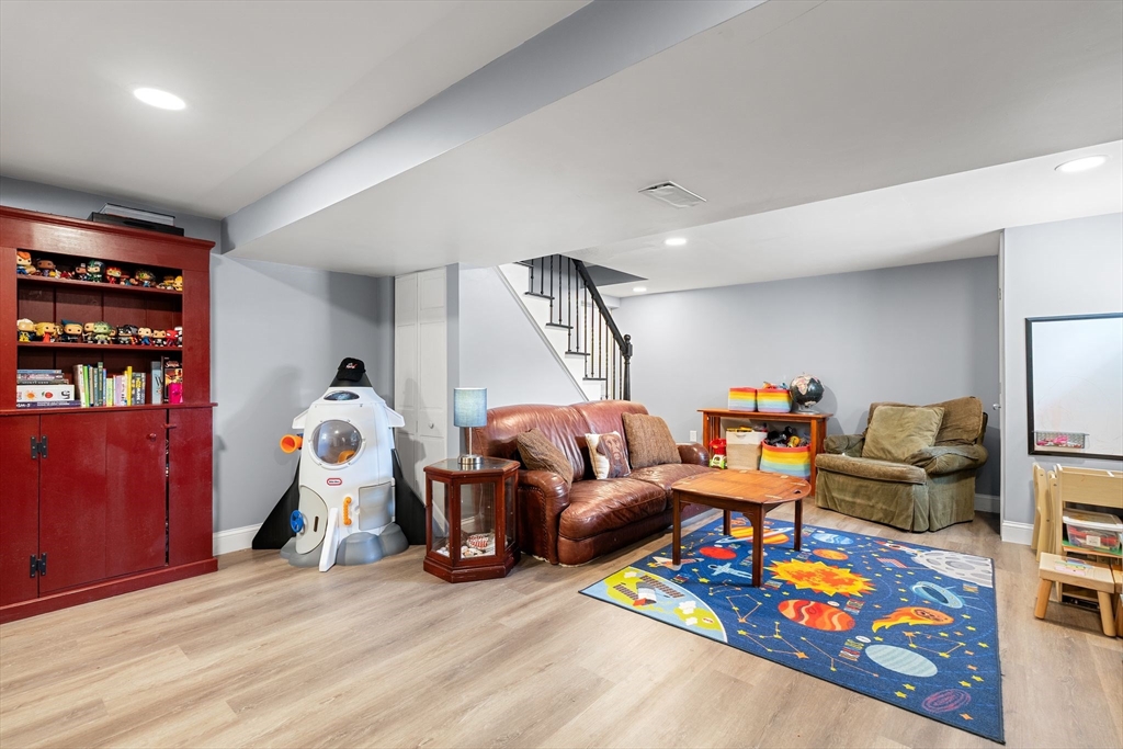 35 Spallus Road Stoughton, MA 02072 - Photo 32 of 39 a living room with furniture a rug and gym equipment