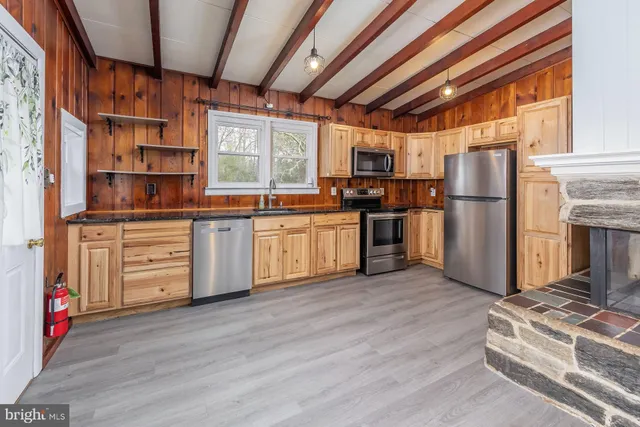 a kitchen with stainless steel appliances granite countertop a refrigerator and a stove