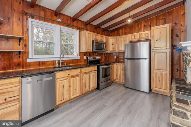 a kitchen with stainless steel appliances a refrigerator and a sink