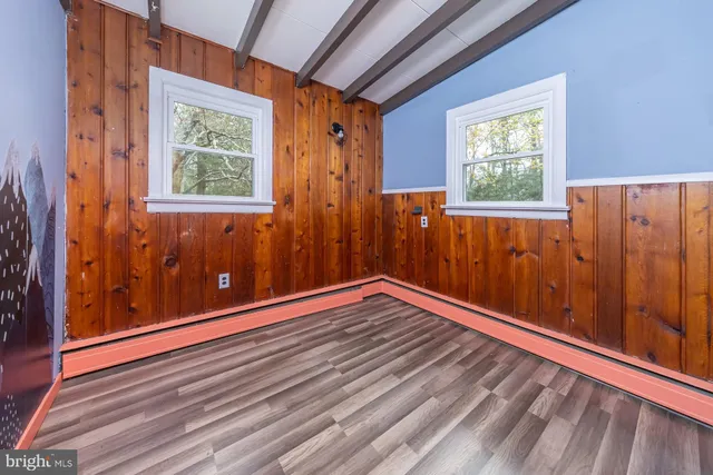 a view of a room with wooden floor and windows