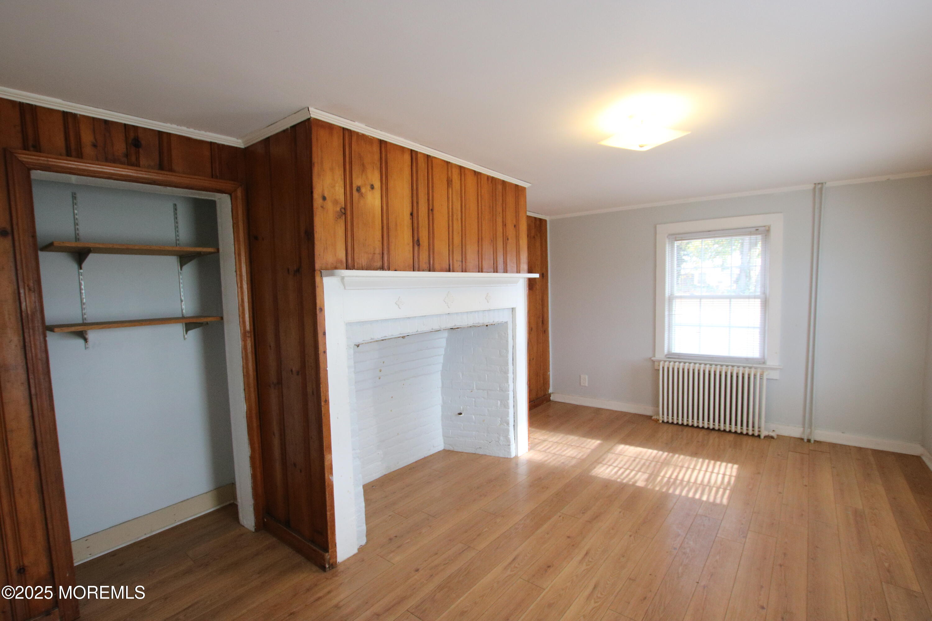 185 Monmouth Road West Long Branch, NJ 07764 - Photo 5 of 28 an empty room with wooden floor cabinet and windows