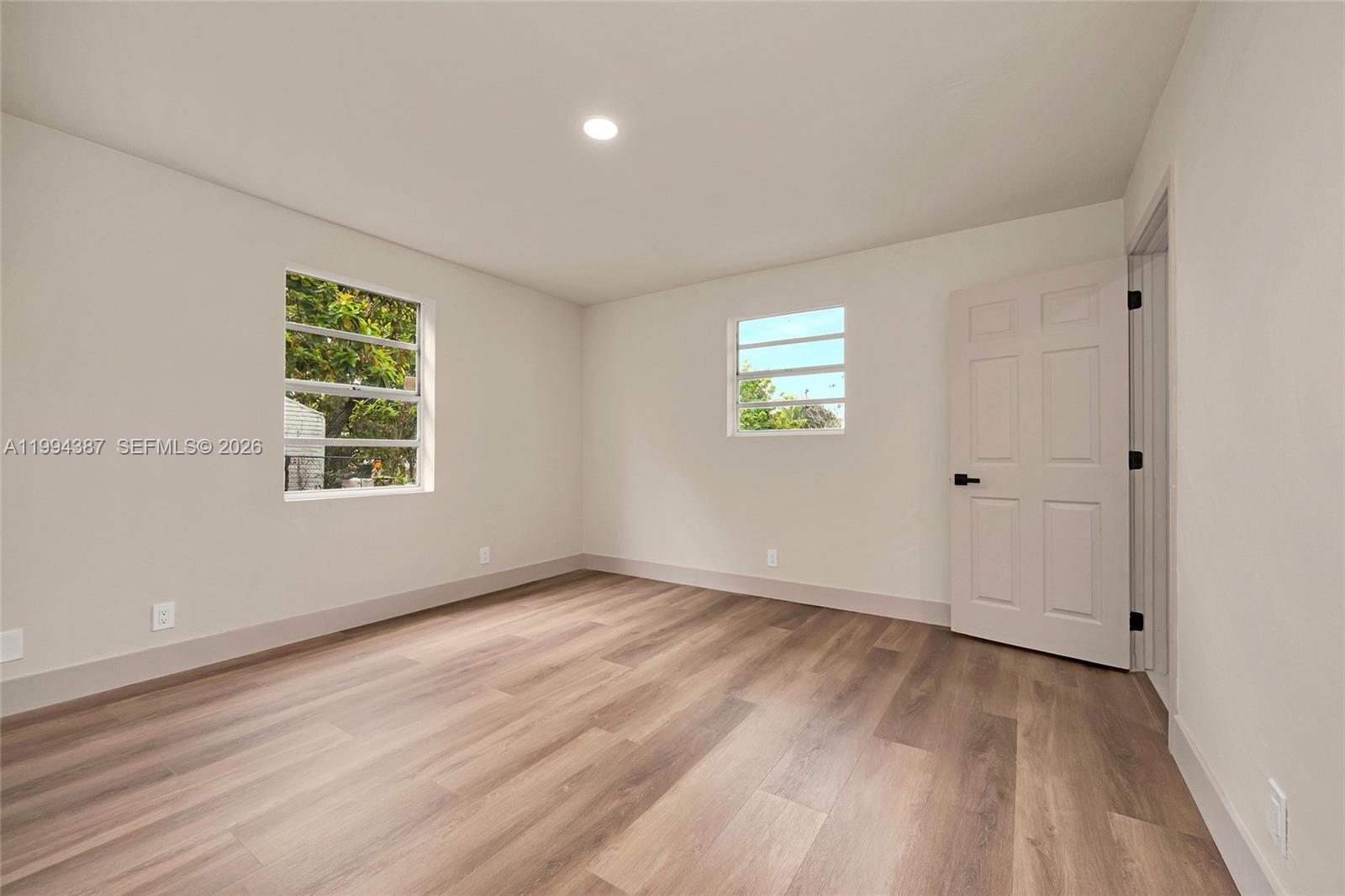 5632 Southwest 19th Street West Park, FL 33023 - Photo 12 of 43 a view of an empty room with wooden floor and a window
