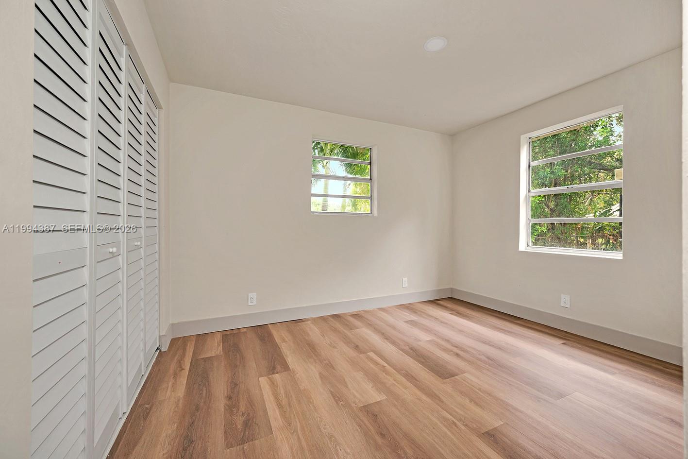 5632 Southwest 19th Street West Park, FL 33023 - Photo 13 of 43 a view of room with window and hardwood floor