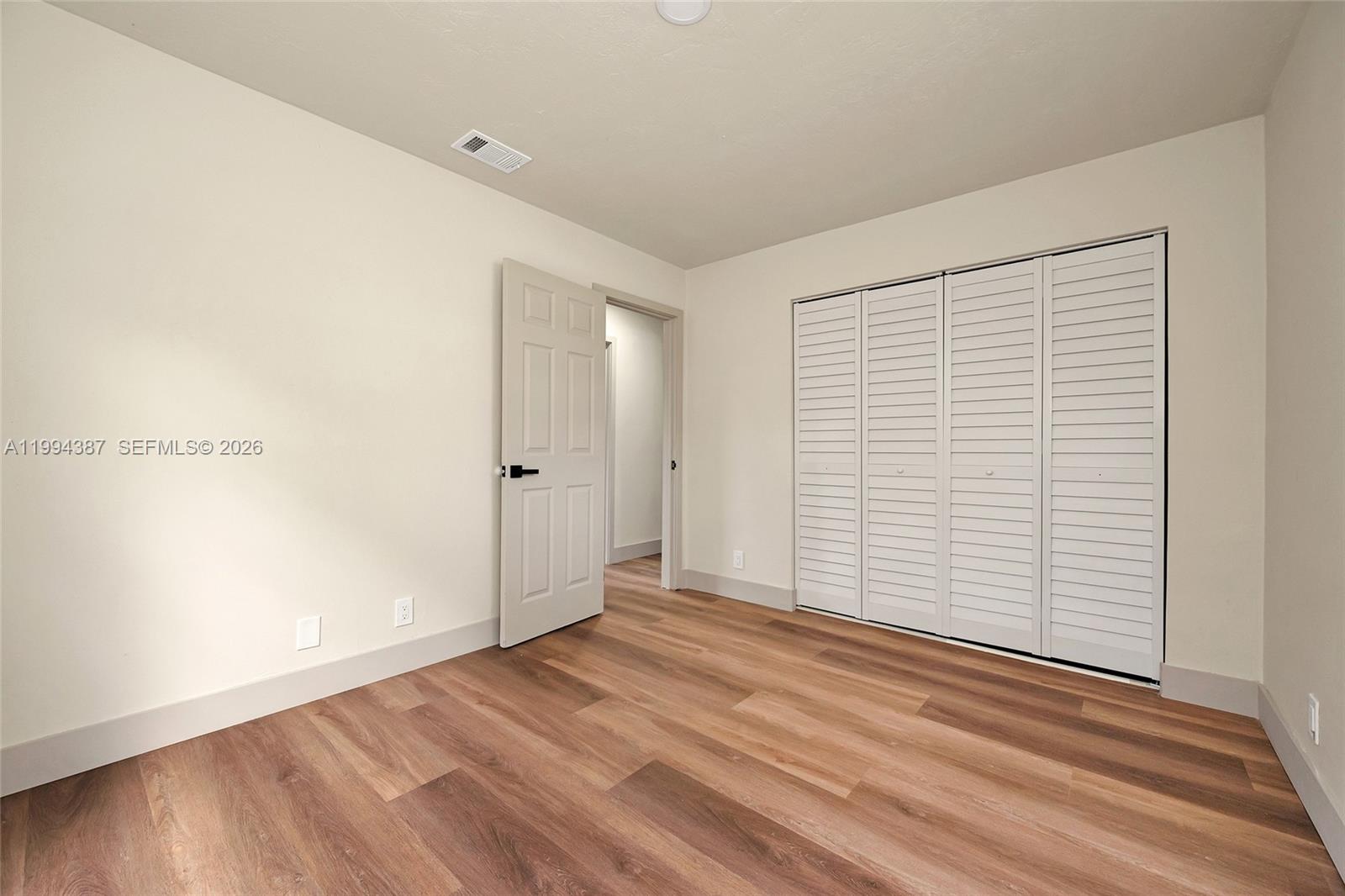 5632 Southwest 19th Street West Park, FL 33023 - Photo 14 of 43 wooden floor in an empty room