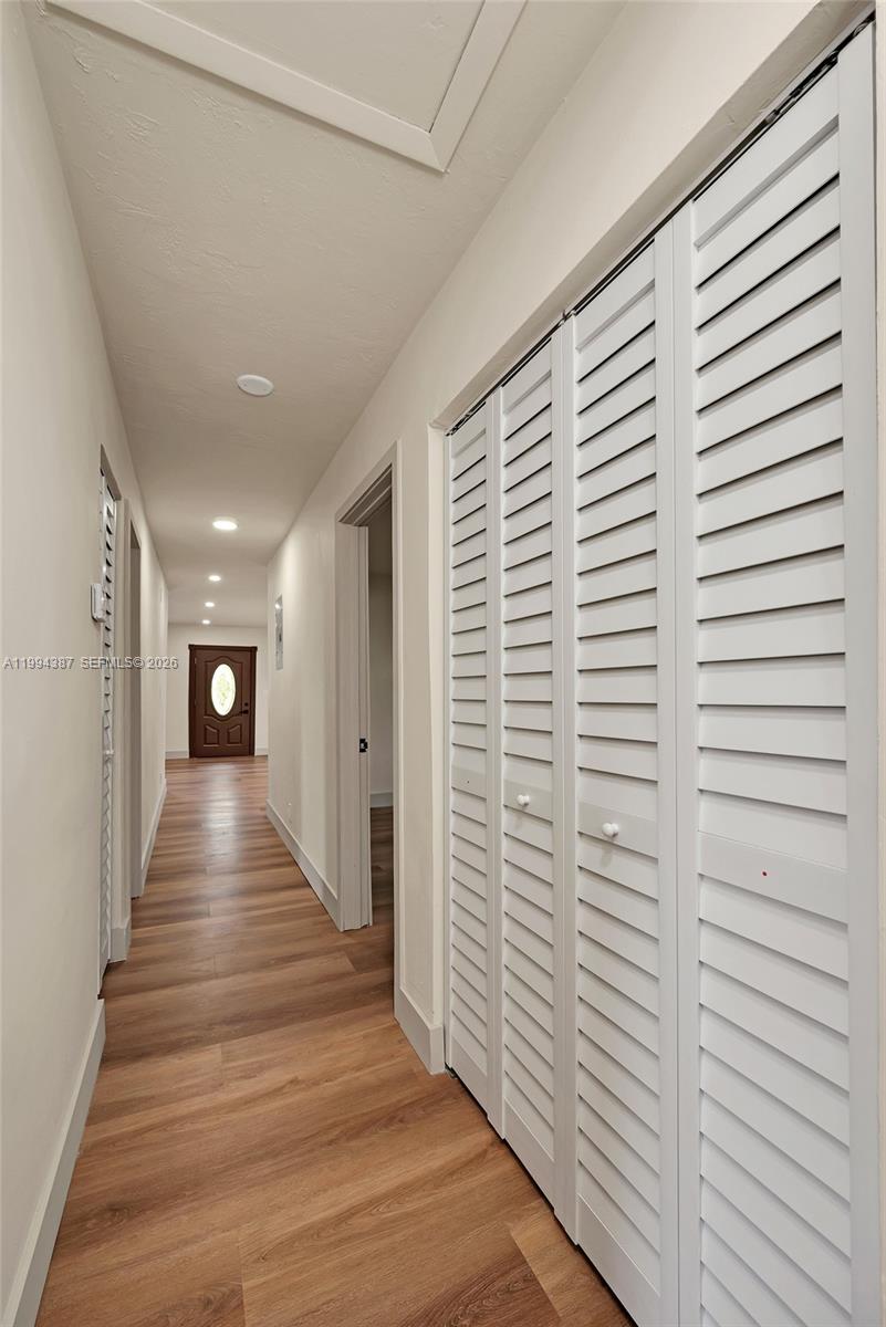 5632 Southwest 19th Street West Park, FL 33023 - Photo 15 of 43 a view of a hallway with stairs and a wooden floor