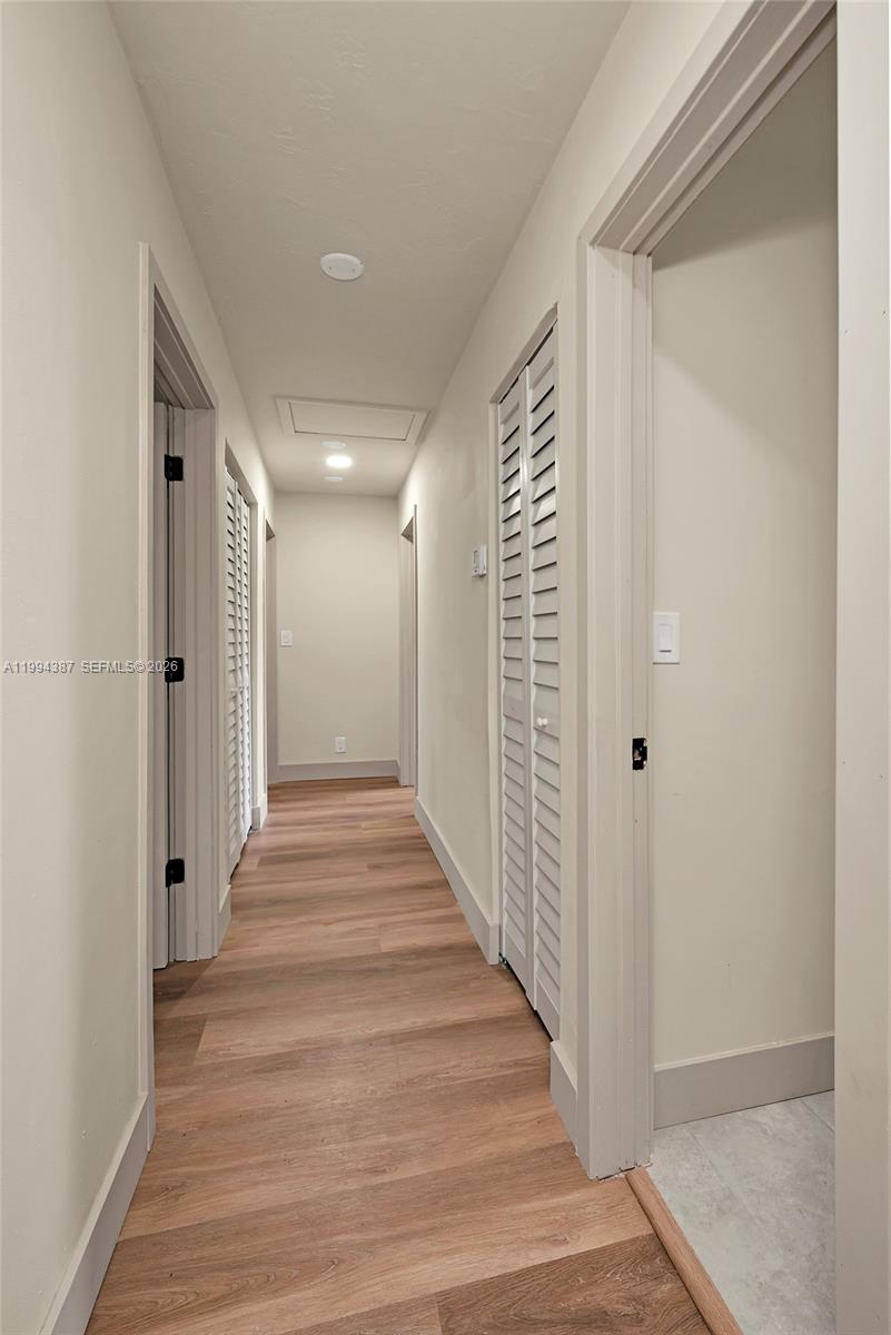 5632 Southwest 19th Street West Park, FL 33023 - Photo 16 of 43 a view of a hallway with wooden floor and closet area