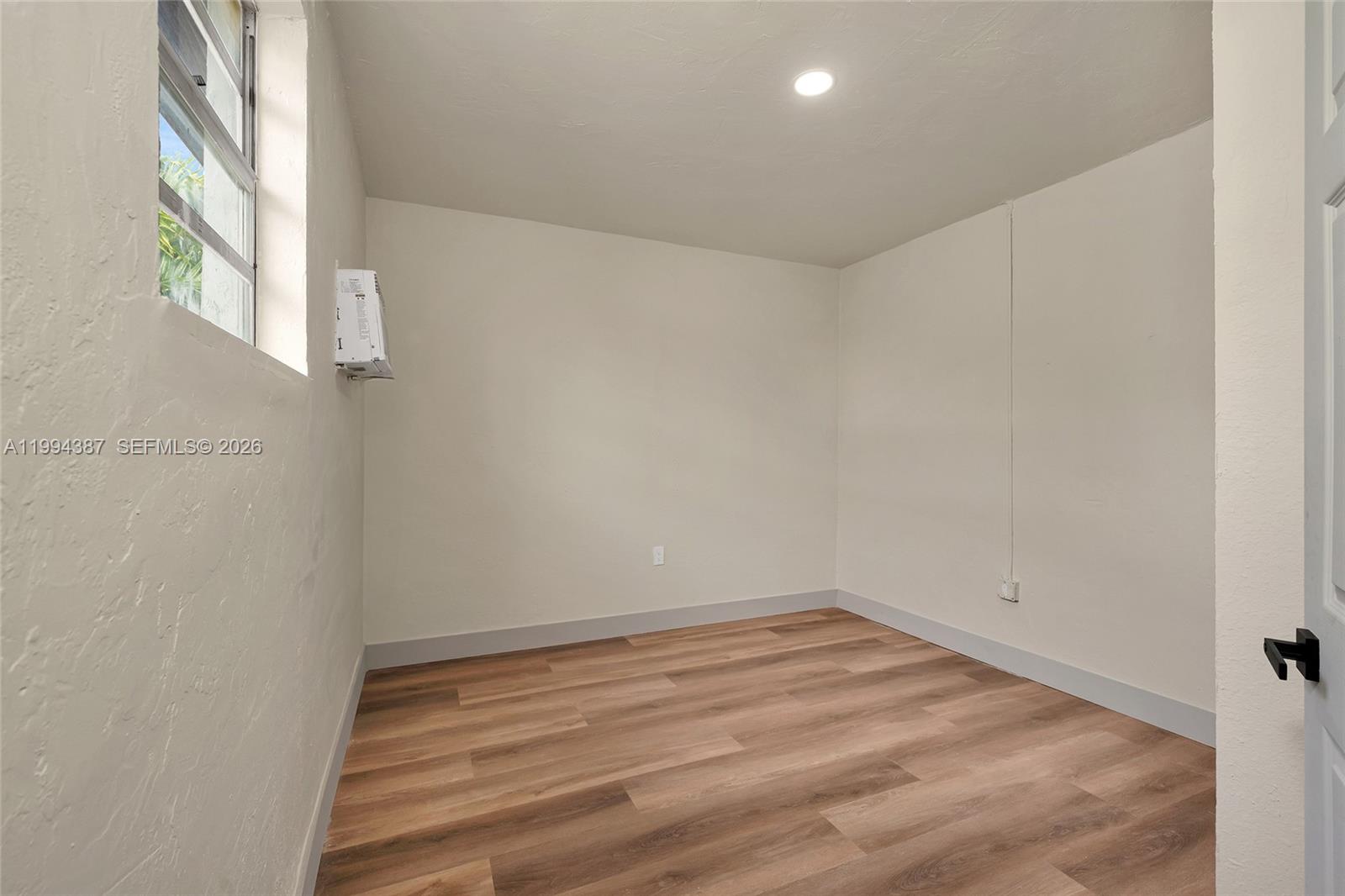 5632 Southwest 19th Street West Park, FL 33023 - Photo 17 of 43 a view of a room with wooden floor and brick walls