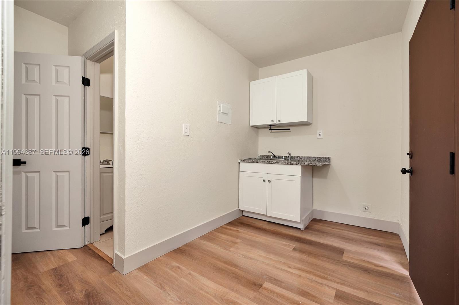 5632 Southwest 19th Street West Park, FL 33023 - Photo 19 of 43 a kitchen with wooden floor and white stove