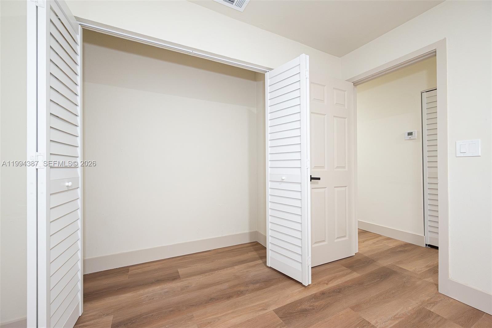 5632 Southwest 19th Street West Park, FL 33023 - Photo 23 of 43 an empty room with wooden floor