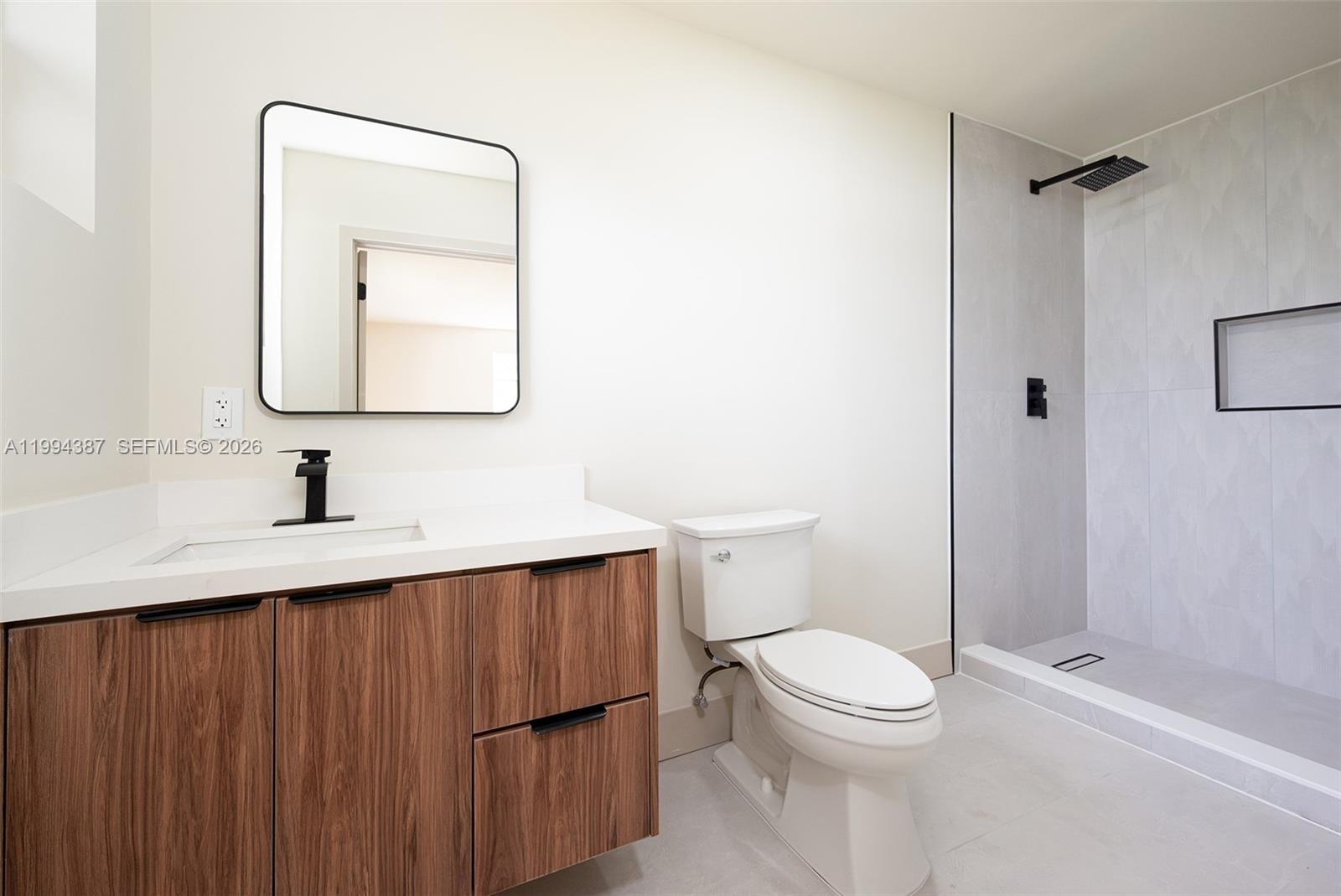 5632 Southwest 19th Street West Park, FL 33023 - Photo 24 of 43 a bathroom with a toilet a sink a vanity and mirror