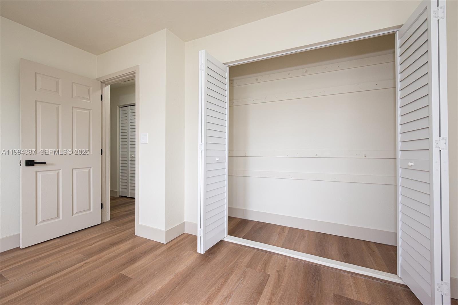 5632 Southwest 19th Street West Park, FL 33023 - Photo 25 of 43 an empty room with wooden floor