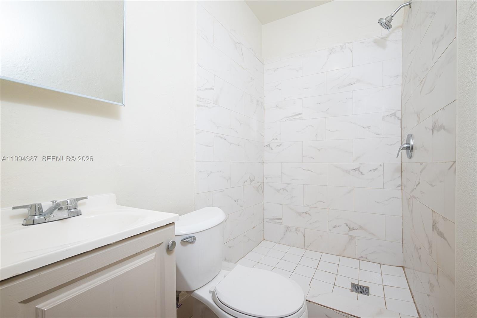 5632 Southwest 19th Street West Park, FL 33023 - Photo 27 of 43 a bathroom with a sink a toilet and shower