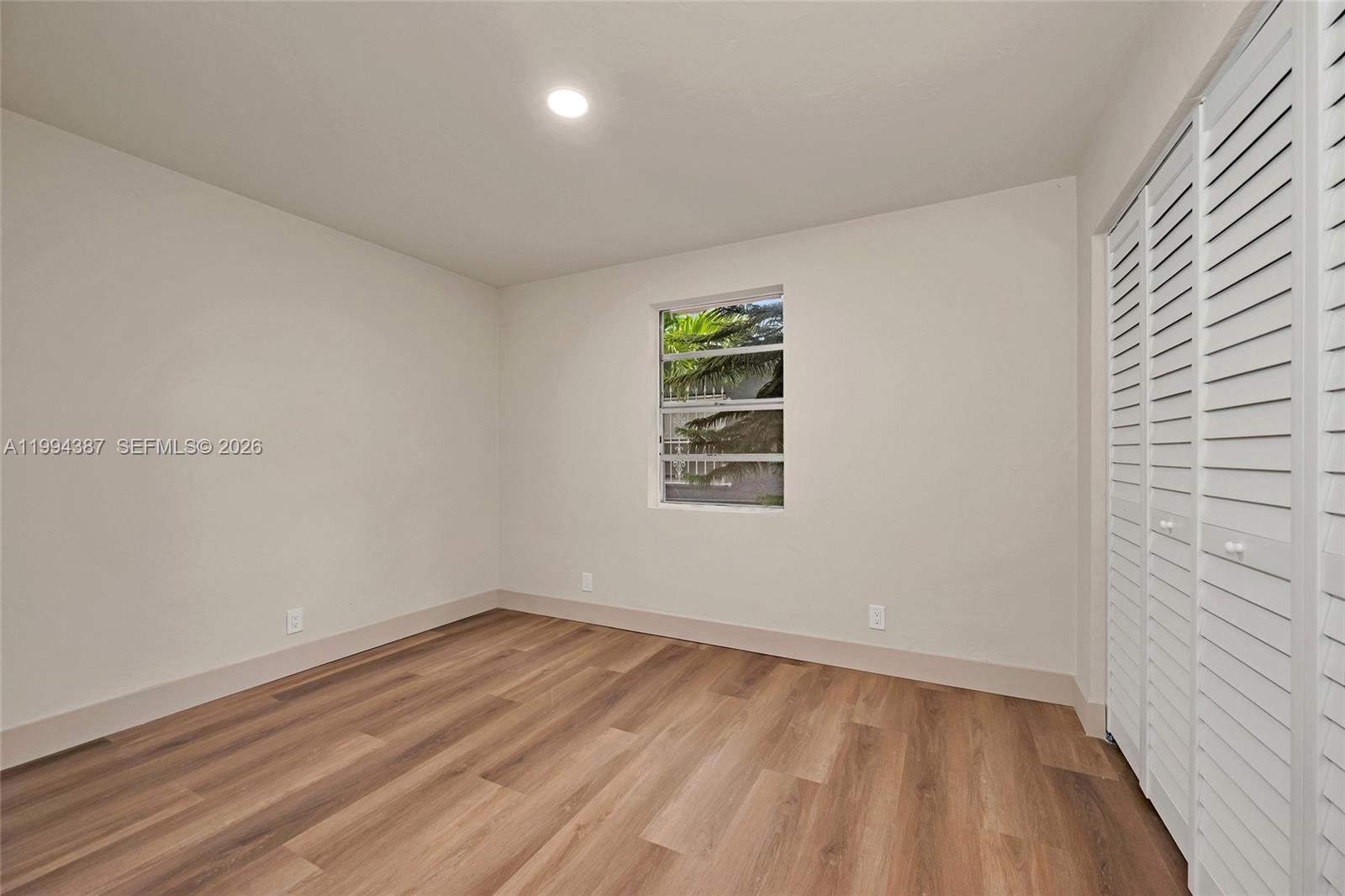 5632 Southwest 19th Street West Park, FL 33023 - Photo 29 of 43 a view of empty room with wooden floor and fan
