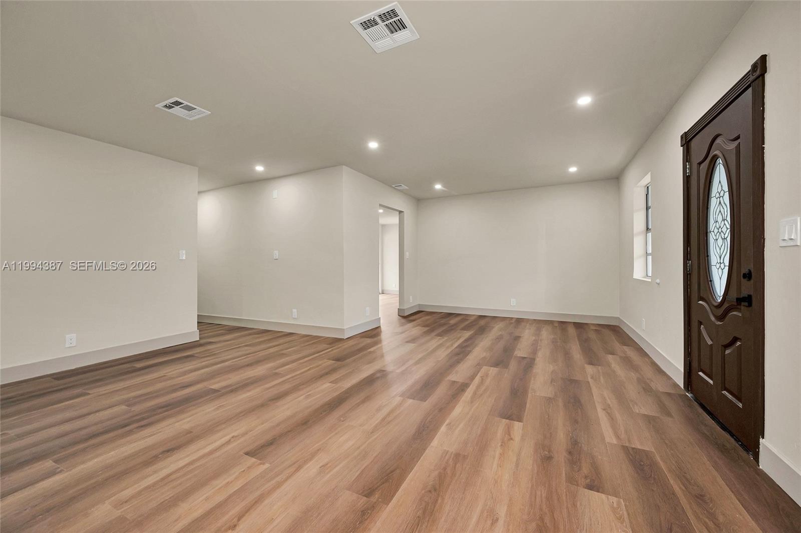 5632 Southwest 19th Street West Park, FL 33023 - Photo 3 of 43 a view of an empty room with wooden floor and a window