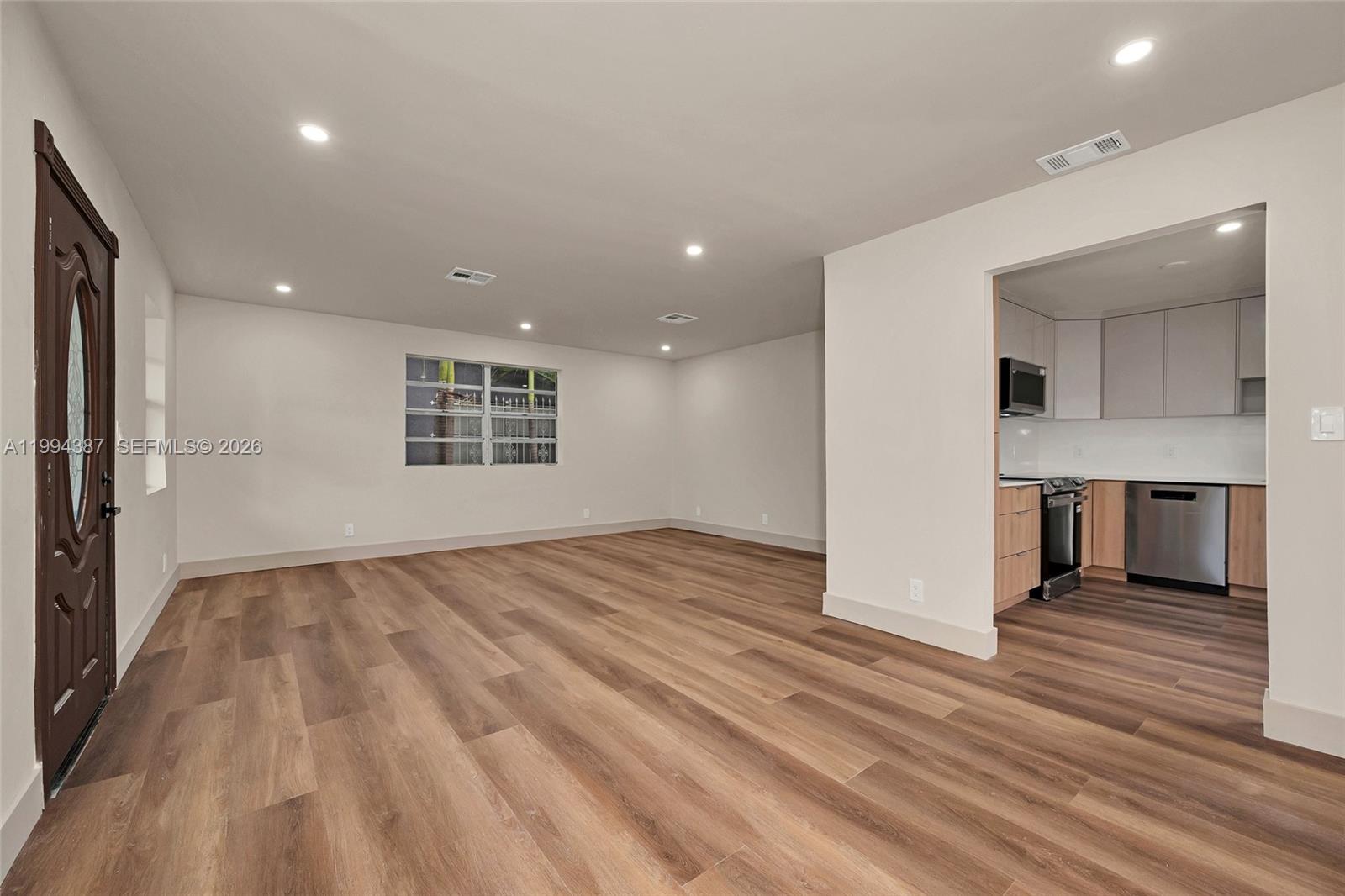 5632 Southwest 19th Street West Park, FL 33023 - Photo 5 of 43 a view of an empty room with a window and wooden floor