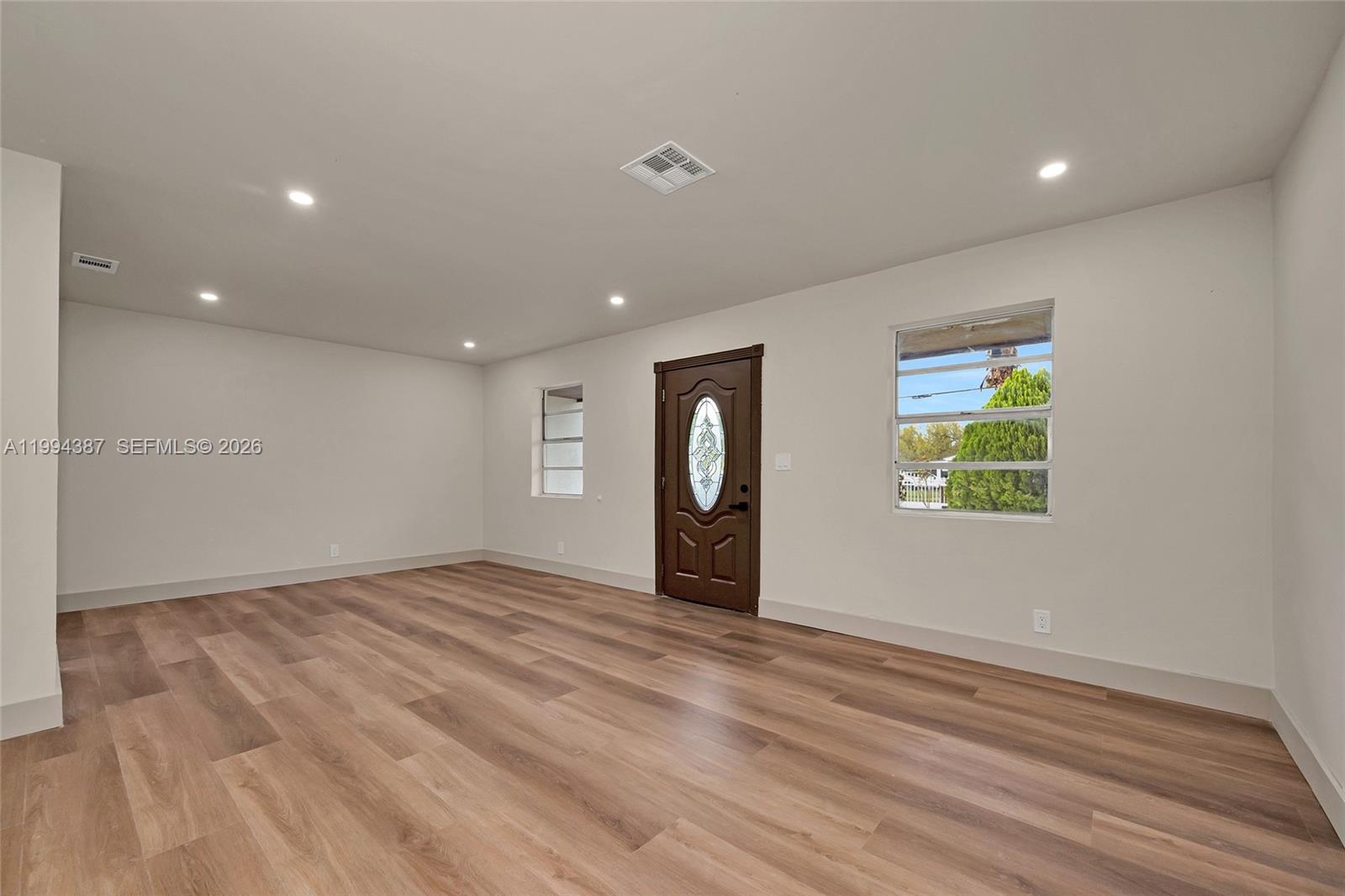 5632 Southwest 19th Street West Park, FL 33023 - Photo 7 of 43 a view of an empty room with wooden floor and a window
