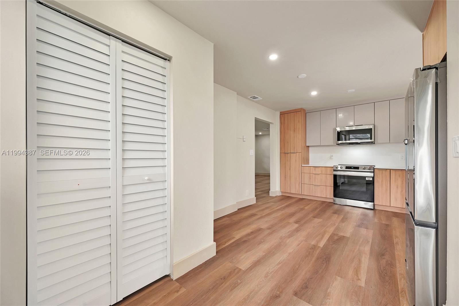 5632 Southwest 19th Street West Park, FL 33023 - Photo 10 of 43 a kitchen with stainless steel appliances a refrigerator and a stove top oven