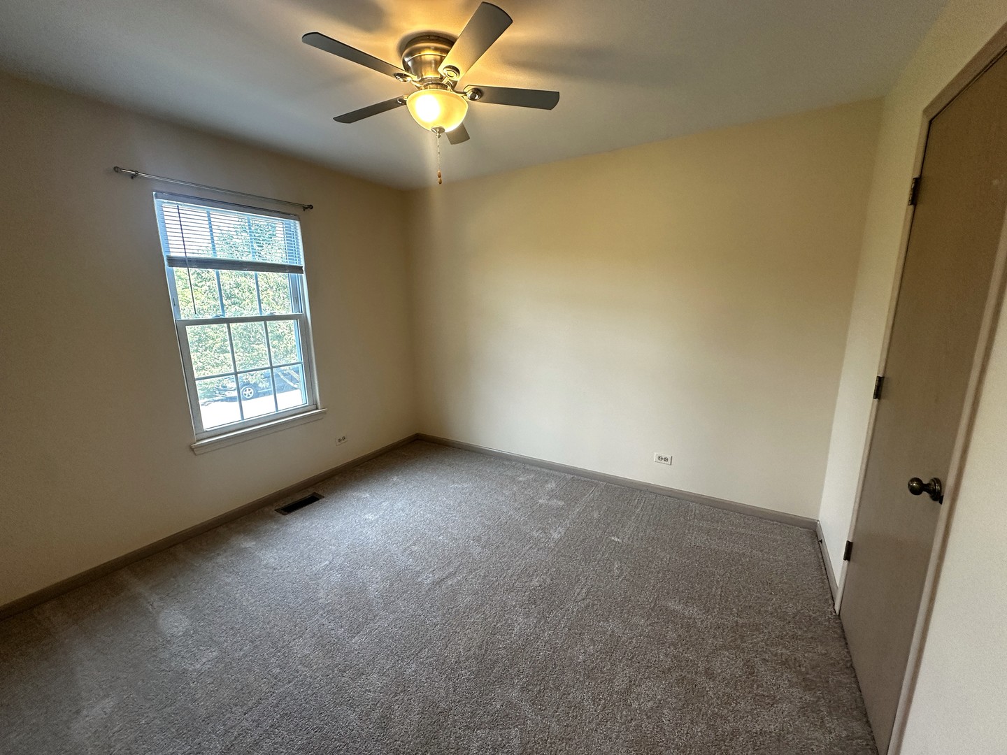 1152 Vail Court Naperville, IL 60540 - Photo 6 of 11 an empty room with windows and fan