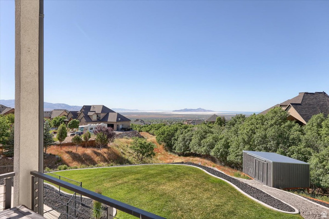828 South Deer Road Tooele, UT 84074 - Photo 45 of 51 Expansive terraced yard featuring a manicured lawn, a stone pathway, a modern shed, and mature trees