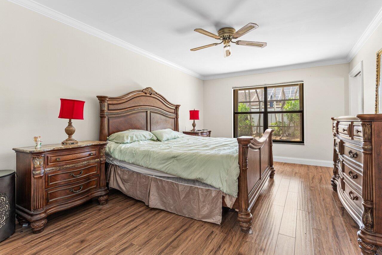 7800 Texas Trail Boca Raton, FL 33487 - Photo 15 of 33 a bedroom with a bed and a chandelier