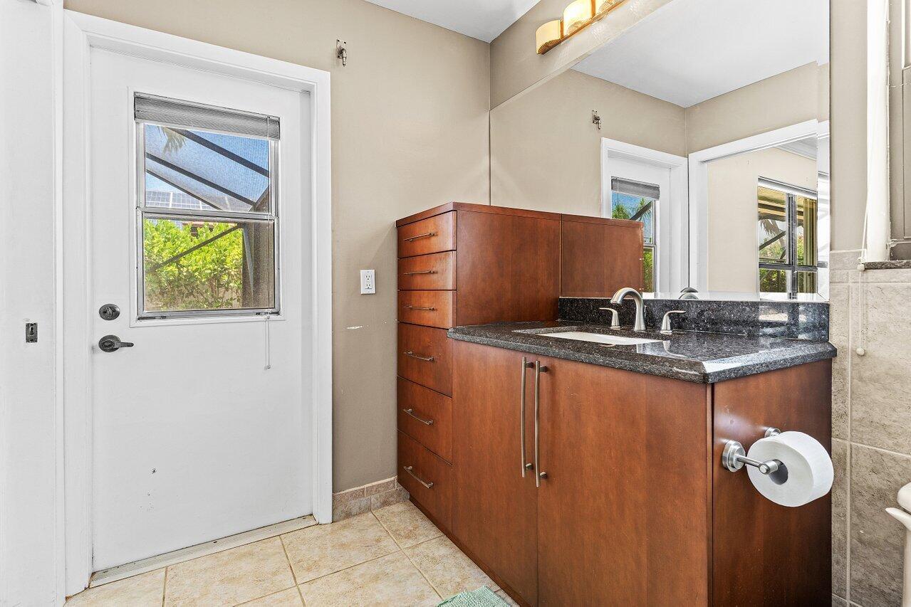 7800 Texas Trail Boca Raton, FL 33487 - Photo 18 of 33 a bathroom with a granite countertop sink and a mirror