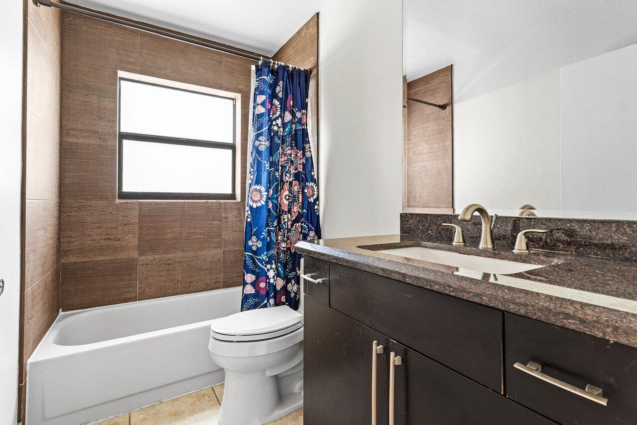 7800 Texas Trail Boca Raton, FL 33487 - Photo 20 of 33 a bathroom with a granite countertop sink toilet a mirror and bathtub