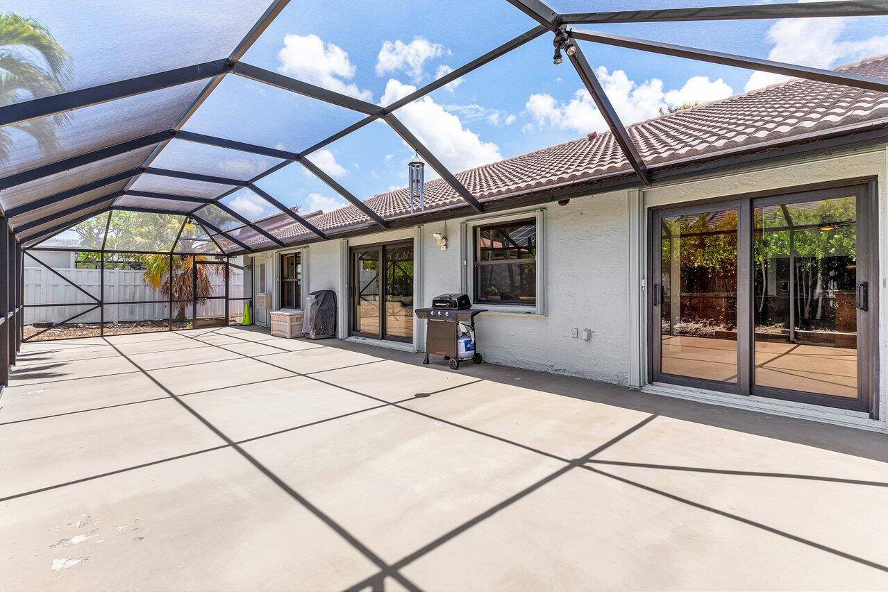 7800 Texas Trail Boca Raton, FL 33487 - Photo 25 of 33 a view of a hall with the floor and a ceiling fan