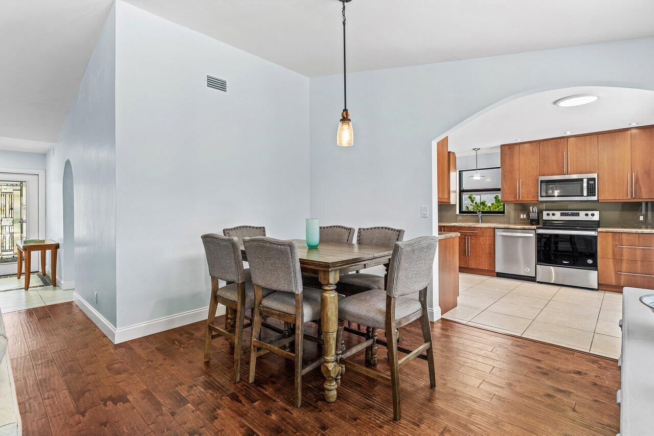 7800 Texas Trail Boca Raton, FL 33487 - Photo 8 of 33 a view of a dining room with furniture and wooden floor