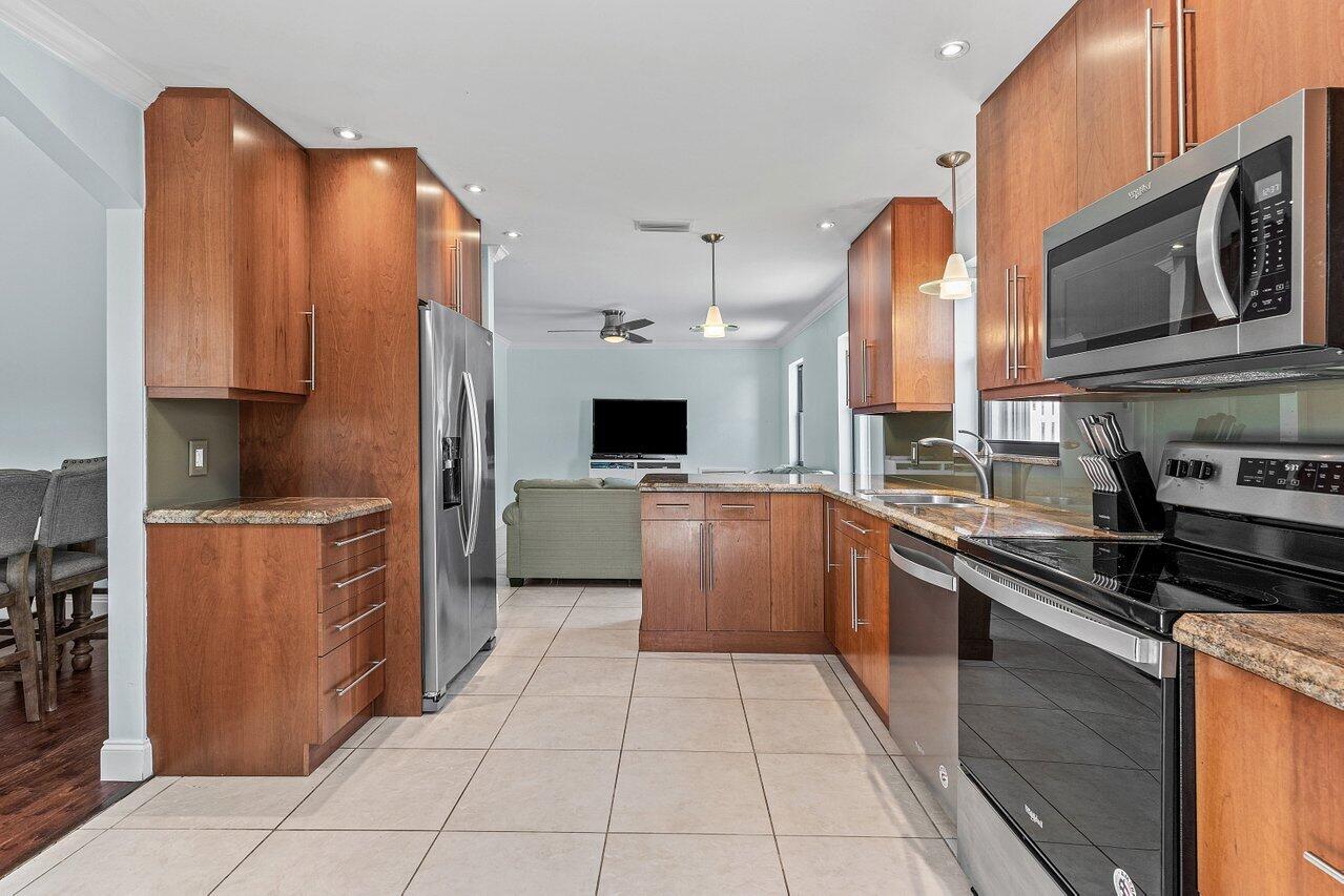 7800 Texas Trail Boca Raton, FL 33487 - Photo 10 of 33 a kitchen with stainless steel appliances a sink and a refrigerator