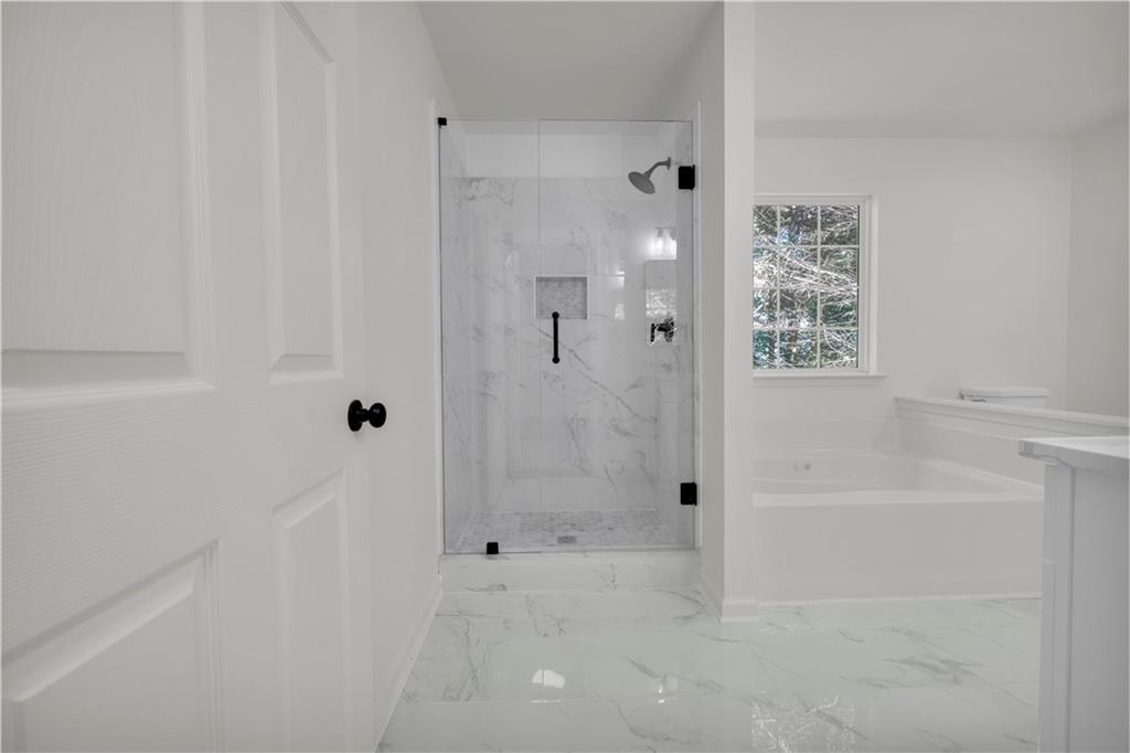 2941 Lake Hollow Road Gainesville, GA 30501 - Photo 27 of 53 a bathroom with a bathtub and shower