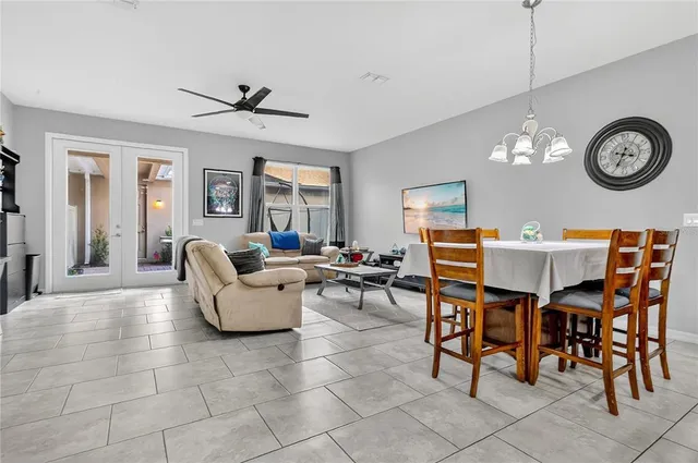 a living room with furniture a clock and a window