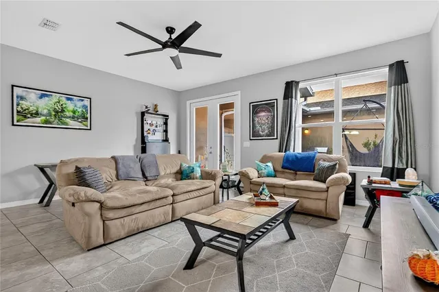 a living room with furniture and a large window