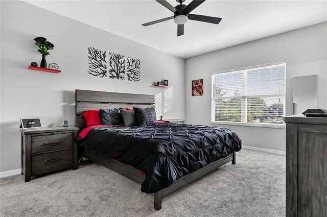 a bed sitting in a bedroom next to a window