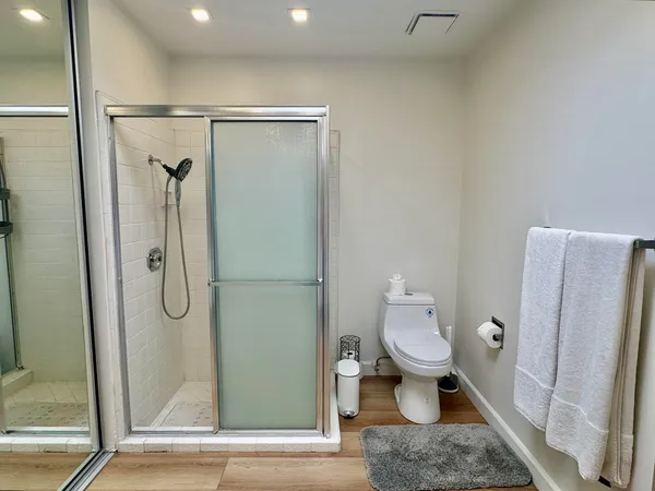 a bathroom with a granite countertop shower and a toilet