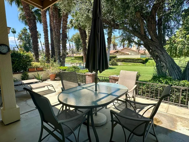 a patio with a yard table and chairs